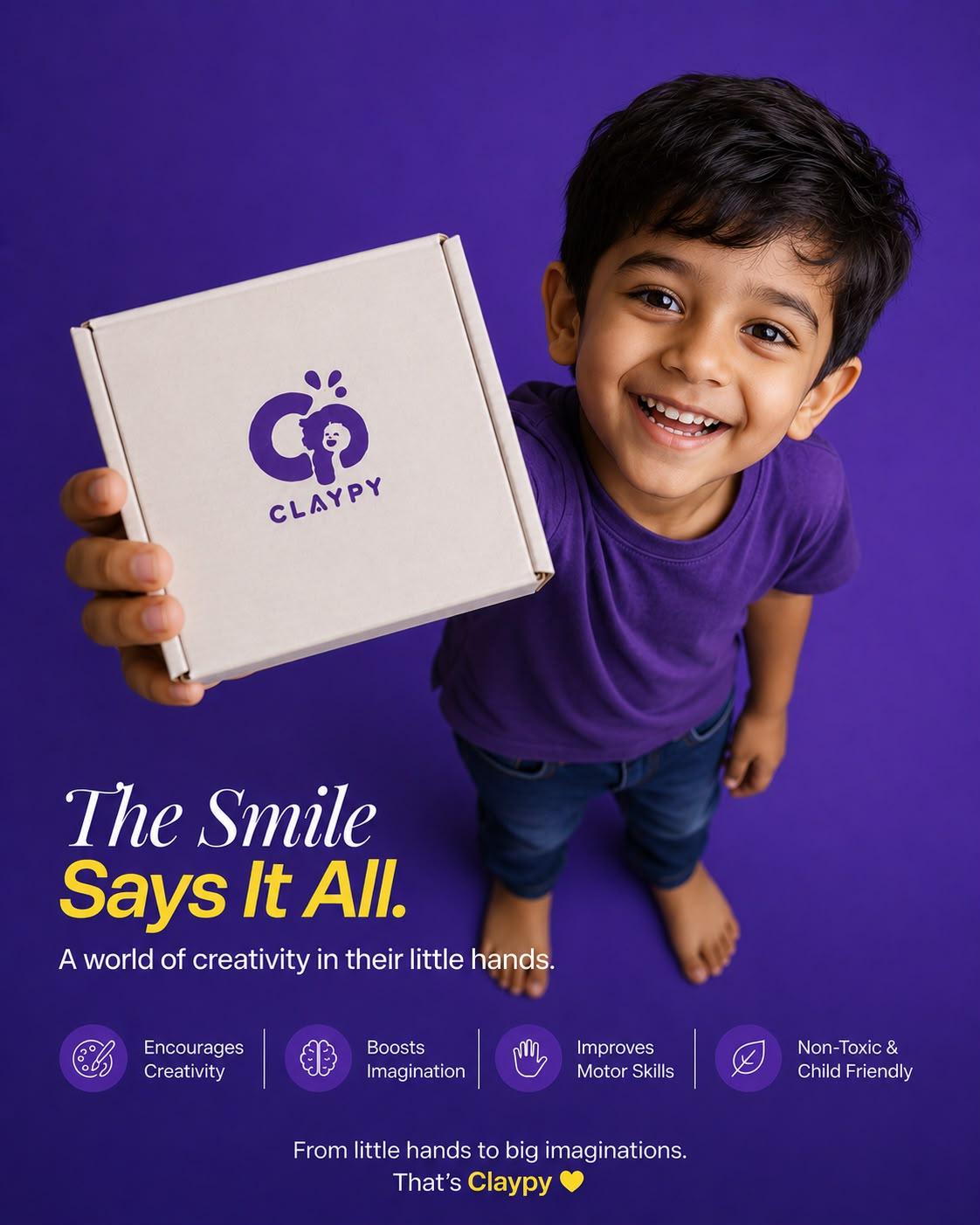 Child smiling while holding a Claypy DIY painting kit box